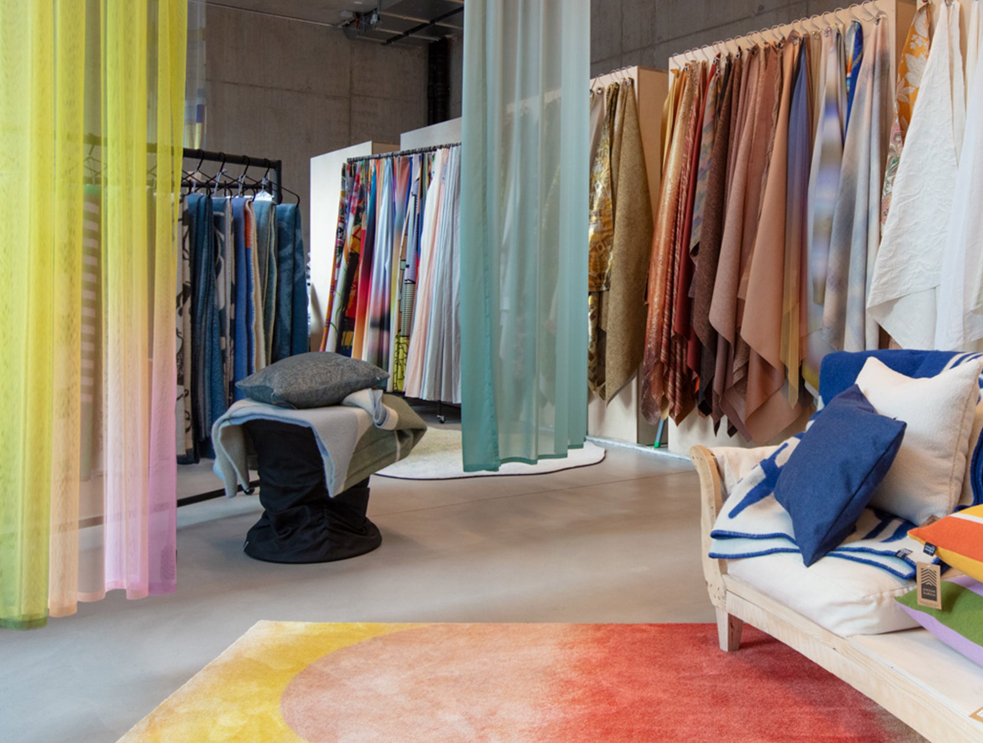 4Spaces Zurich showroom with layered curtains and textile samples