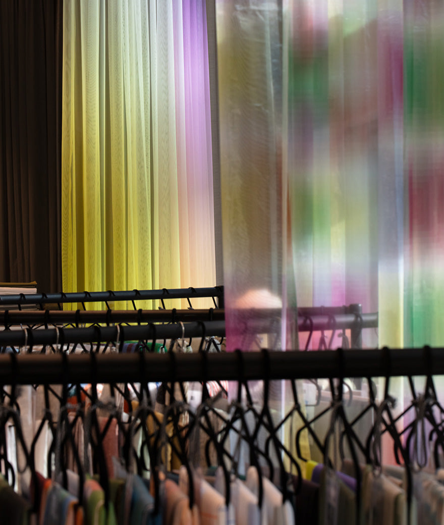 Showroom seating corner beside a window and pastel curtains